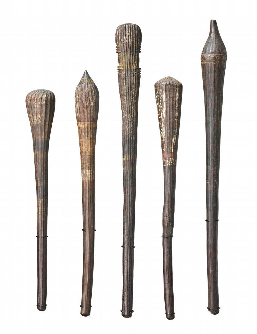 A GROUP OF FIVE TIWI THROWING CLUBS