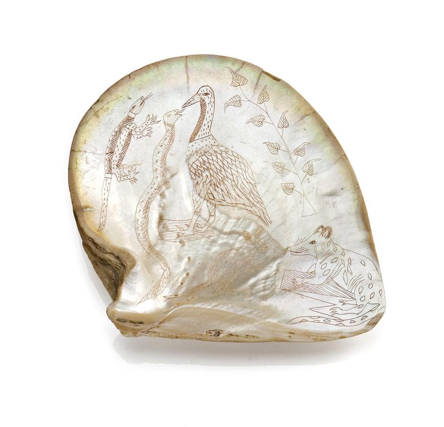 AN ENGRAVED PEARL SHELL