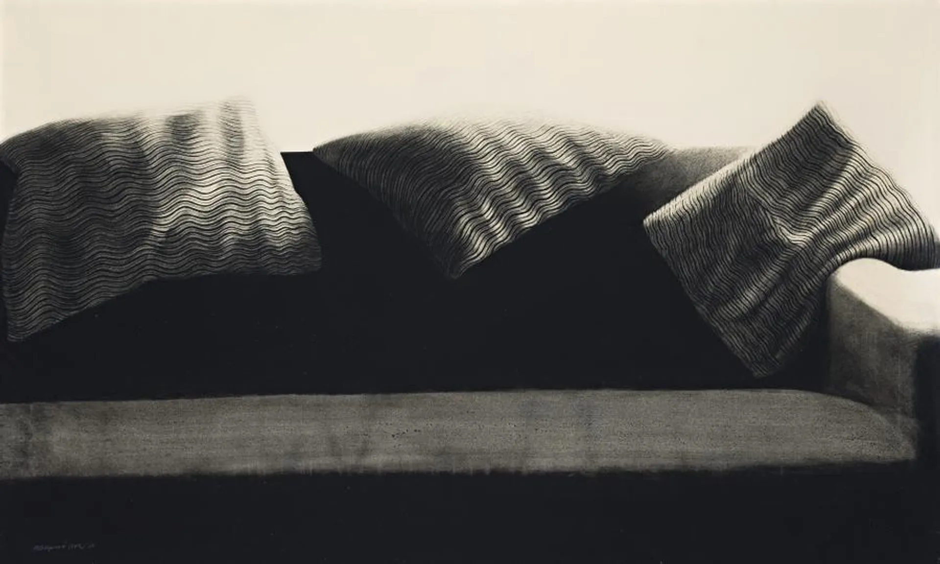 A SOFA WITH CUSHIONS ON TOP