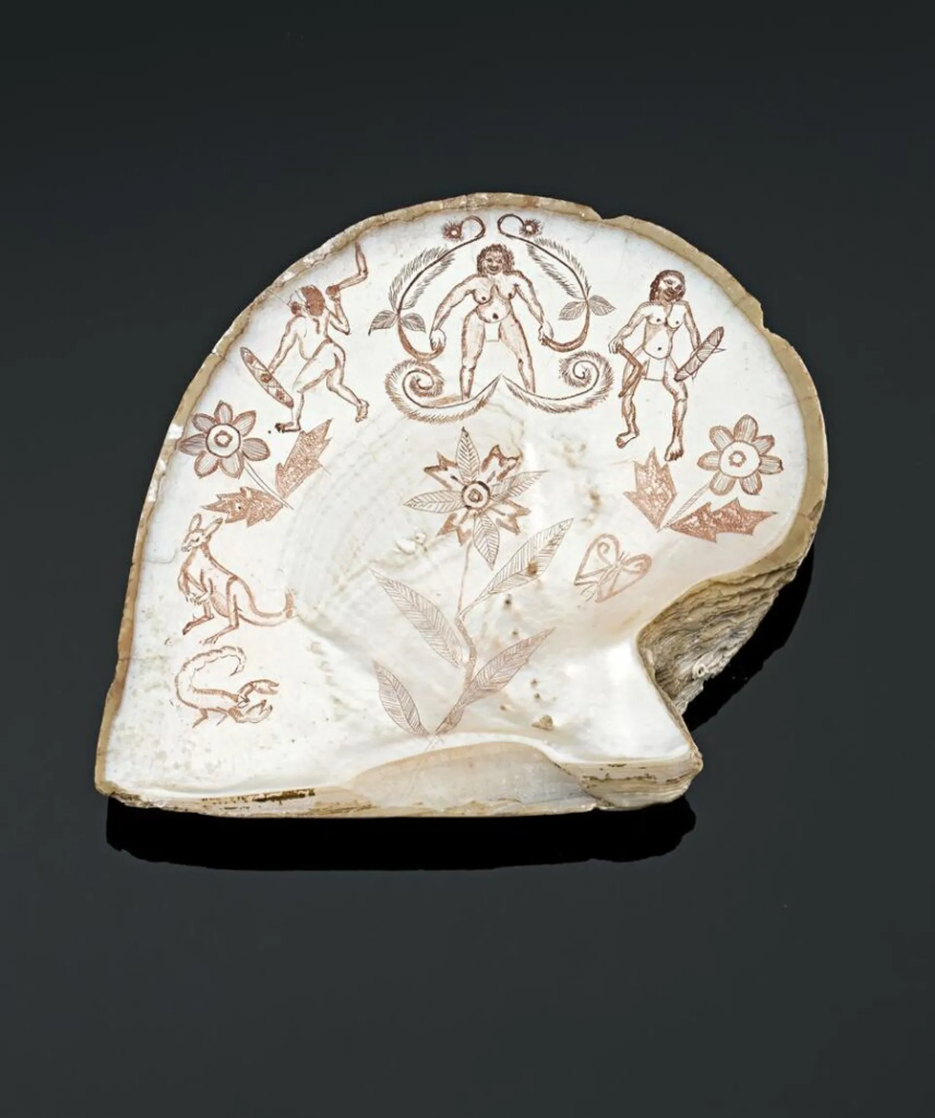 AN ENGRAVED PEARL SHELL