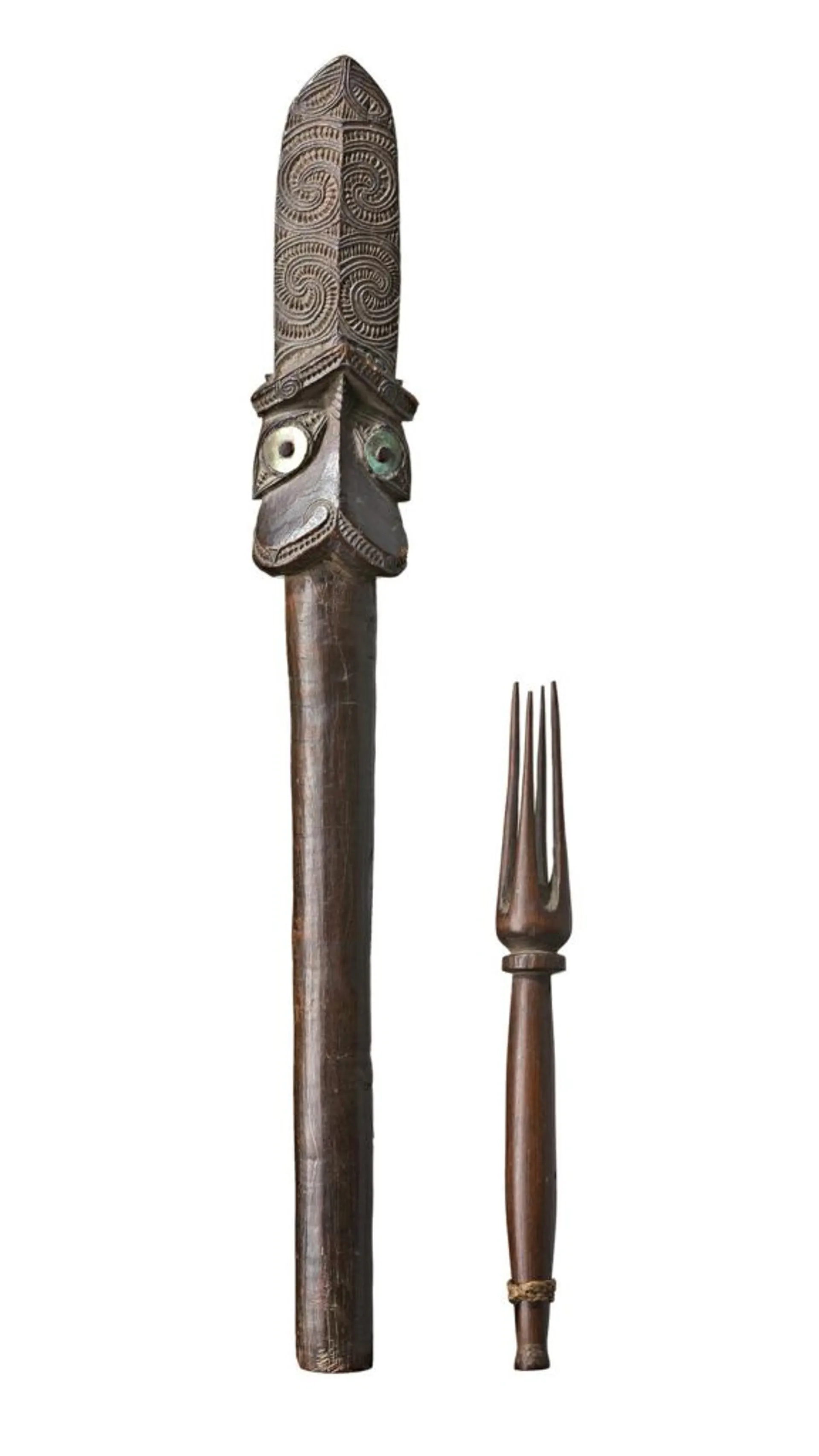 the Taiaha of carved hardwood with intricately incised designs in laid with mother of pearl; the fork of carved and polished hardwood with four prongs with plaited fibre band at the handle
