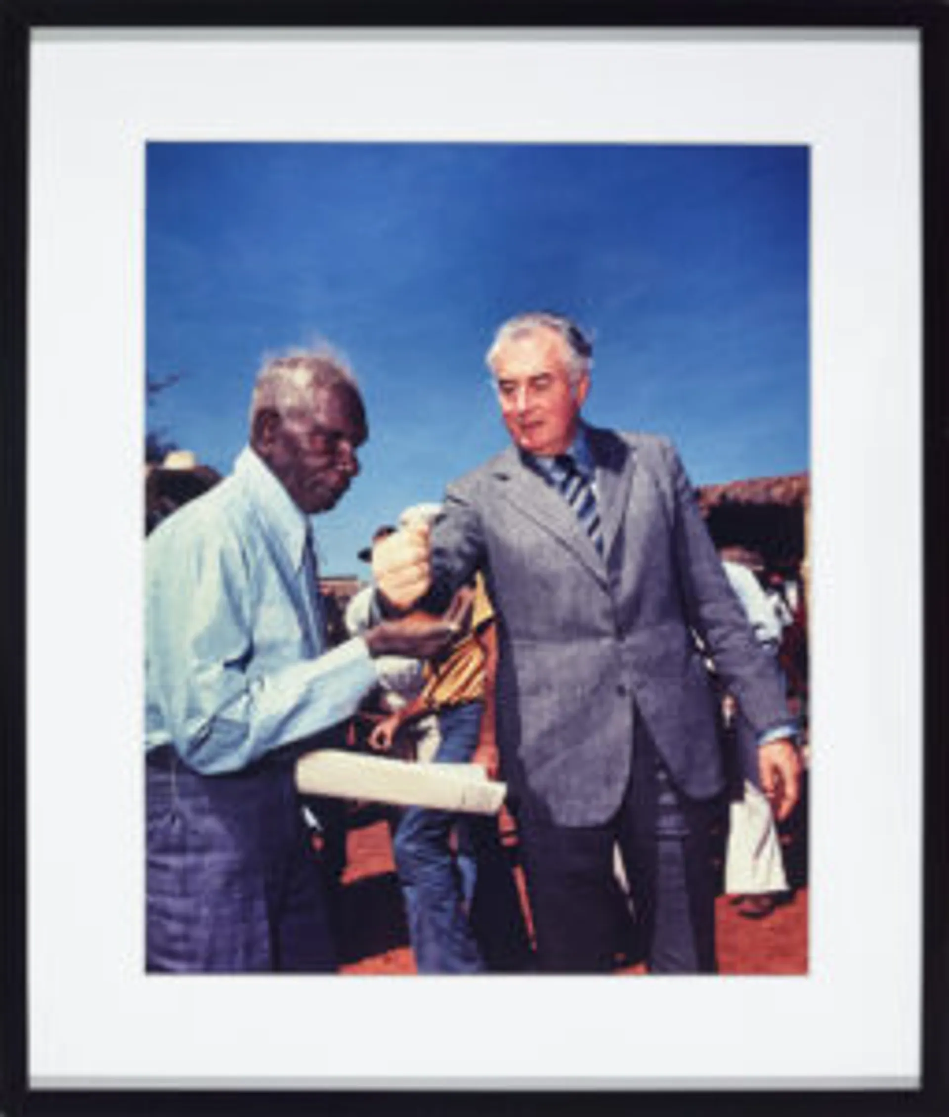 PRIME MINISTER GOUGH WHITLAM POURS SOIL INTO THE HANDS OF TRADITIONAL LANDOWNER VINCENT LINGIARI, NORTHERN TERRITORY